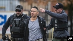 Solomon Pena, a Republican candidate for New Mexico House District 14, is taken into custody by Albuquerque Police officers, Jan. 16, 2023, in southwest Albuquerque, N.M. (Roberto E. Rosales/The Albuquerque Journal via AP)