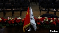 The flags of China and Afghanistan's Taliban are displayed during a news conference in Kabul, Afghanistan, on Jan. 5, 2023. A gun attack claimed by an Islamic State affiliate killed a Chinese national in northeast Afghanistan, the Taliban announced on Jan. 22, 2025.