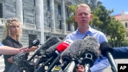 New Zealand Education Minister Chris Hipkins talks to reporters outside parliament in Wellington, New Zealand, Jan. 21, 2022. 