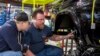 A student from McPherson College works restoring a Ford Bronco during a summer internship.