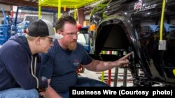 A student from McPherson College works restoring a Ford Bronco during a summer internship.