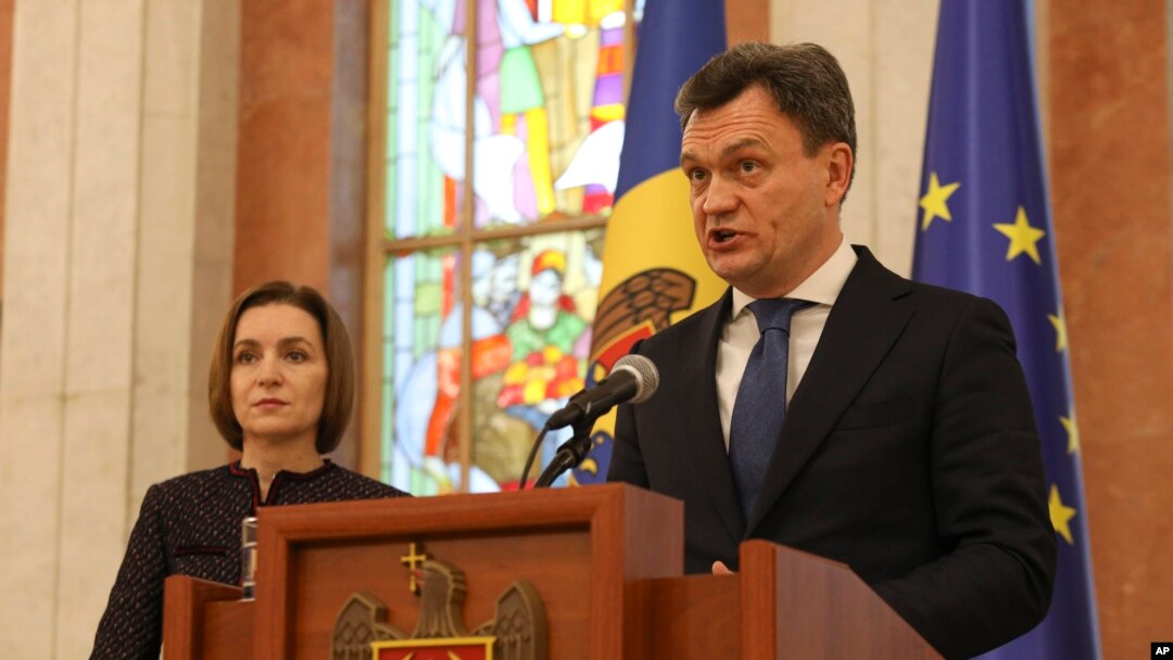 Moldovan Prime Minister designate Dorin Recean speaks after being appointed by President Maia Sandu, left, to form a new government in Chisinau, Moldova, Feb 10, 2023. 