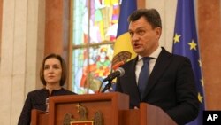 Moldovan Prime Minister designate Dorin Recean speaks after being appointed by President Maia Sandu, left, to form a new government in Chisinau, Moldova, Feb 10, 2023. 