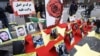 Foto-foto korban tewas dalam demonstrasi di Iran saat berlangsungnya protes solidaritas anggota komunitas Iran dan pendukung Dewan Nasional Iran di Paris, Prancis, 12 Februari 2023. (REUTERS/Yves Herman)