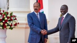 Eritrea's President Isaias Afwerki, left, shakes hands with Kenya's President William Ruto after speaking to the media at State House in Nairobi, Kenya, Feb. 9, 2023. 