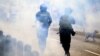 Riot police fire tear gas at demonstrators during a protest against the government of Dina Boluarte asking for her resignation and the closure of Congress, in Lima on Jan. 24, 2023.