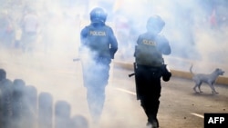 Riot police fire tear gas at demonstrators during a protest against the government of Dina Boluarte asking for her resignation and the closure of Congress, in Lima on Jan. 24, 2023.