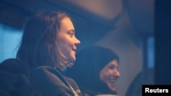 Climate activist Greta Thunberg sits in a bus with other activists on the day of a protest against the expansion of the Garzweiler open-cast lignite mine of Germany's utility RWE to Luetzerath, in Germany, Jan. 17, 2023 .