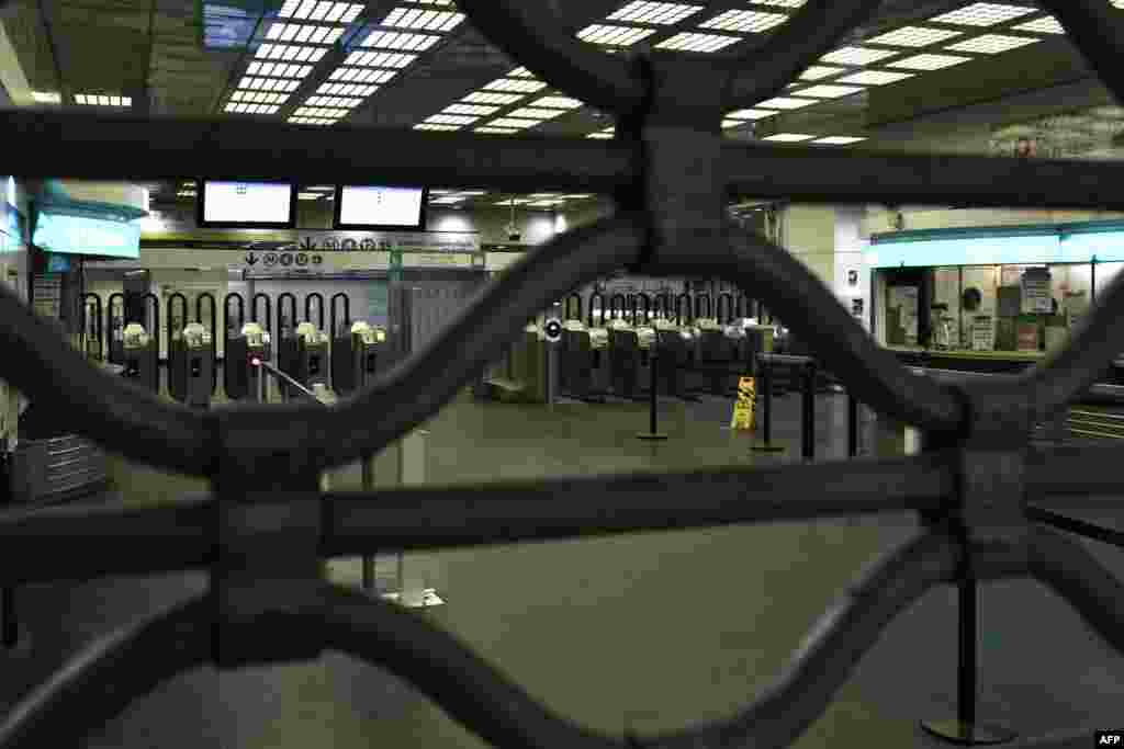 A metal curtain closes off access to Montparnasse metro station in Paris, as workers go on strike over the French President's plan to raise the legal retirement age from 62 to 64.