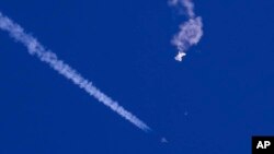FILE - In this photo provided by Chad Fish, the remnants of a large balloon drift above the Atlantic Ocean, just off the coast of South Carolina, after being shot down by U.S. jet fighter on Feb. 4, 2023. (Chad Fish via AP, File)