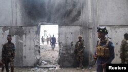 Somali security forces stand outside the mayor's office following a blast in Mogadishu, Jan. 22, 2023.