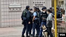 香港西九龍裁判法院大樓一幅玻璃幕牆懷疑被人射擊破裂後，警方加強戒備，帶同警犬在法院正門入口駐守。(美國之音湯惠芸)