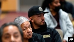 Residents of Gila River Indian Community listen during a 'Road to Healing' event, Jan. 20, 2023, at the Gila Crossing Community School in Laveen, Ariz.