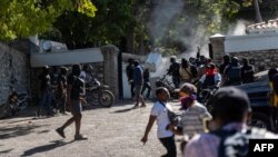 Police besiege the official home of the prime minister during a demonstration after the deaths of several officers, in Port-au-Prince, Haiti, Jan. 26, 2023.