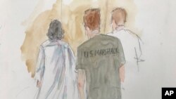 In this courtroom sketch, Ruslan Maratovich Asainov, left, is escorted into federal court, Feb. 7, 2023, in New York.