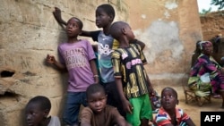 FILE—A group of displaced children gather in the court of a house in Segou on September 30, 2019 In central Mali,