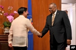 U.S. Secretary of Defense Lloyd James Austin III shake hands with Philippine President Ferdinand Marcos Jr. during a courtesy call at the Malacanang Palace in Manila, Feb. 2, 2023.