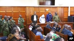 In dock from left to right, Peter Ngugi, Sylvia Wanjohi, Stephen Cheburet and Fredrick Leliman were sentenced in connection with the murders of three people, at Kenya's Milimani court, Feb. 3, 2023. 