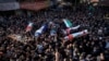 Mourners carry the bodies of eight Palestinians, some draped in the flag of the Islamic Jihad group, during a joint funeral in the West Bank city of Jenin, Jan. 26, 2023.