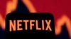 Un teléfono inteligente con el logotipo de Netflix se ve frente a un gráfico de acciones en esta ilustración tomada el 19 de abril de 2022.
