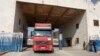 Trucks carrying tent and shelter kits provided by the United Nations in the aftermath of a deadly earthquake, enter Syria's Bab al-Hawa border crossing with Turkey in the rebel-held northwestern province of Idlib, Feb. 12, 2023.