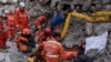 Rescue workers of the Search and rescue unit of the Turkish Gendarmerie General Command work to pull 23-year-old Huseyin Seferoglou from the rubble of a collapsed building in Antakya, Feb. 12, 2023. 