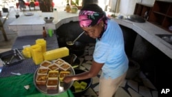 Mireille Lerebours serves traditional soup joumou at a restaurant in the Delmas district of Port-au-Prince, Haiti, Feb. 5, 2023.