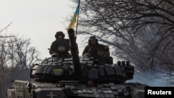 Ukrainian servicemen ride atop a tank near the front line city of Bakhmut, in Ukraine's eastern Donetsk region, Jan. 20, 2023, amid Russia's invasion of its neighbor.