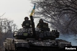 Ukrainian servicemen ride atop a tank near the front line city of Bakhmut, in Ukraine's eastern Donetsk region, Jan. 20, 2023, amid Russia's invasion of its neighbor.