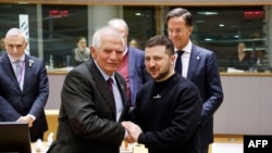 Ukraine's President Volodymyr Zelensky, center, shakes hands with High Representative of the European Union for Foreign Affairs and Security Policy Josep Borrell as part of a EU summit in Brussels, Feb. 9, 2023.