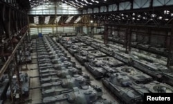 Dozens of German-made Leopard 1 tanks and other armored vehicles are seen in a hangar in Tournais, Belgium, Jan. 31, 2023.