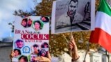 FILE - People hold portraits of Iranian rapper Toomaj Salehi, right, and children, left, who were killed during the protests in Iran, during a rally in Istanbul, Turkey, on Nov. 26, 2022. 