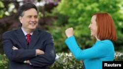 FILE: White House chief of staff Ron Klain and press secretary Jen Psaki in the Rose Garden of the White House in Washington, May 13, 2021. 
