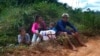 A family rest as they travel for days to leave the Yanomami Indigenous territory ahead of expected operations against illegal mining in Alto Alegre, Roraima state, Brazil, Feb. 7, 2023.