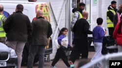 FILE - Migrants are seen inside the Manston short-term holding center near Ramsgate, southeast England, Nov. 3, 2022.