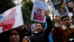 Protesters chant slogans as they hold posters and pictures of victims during a protest against China's brutal crackdown on ethnic group Uyghurs, in front of the Chinese consulate in Istanbul, Turkey, Nov. 30, 2022. 