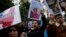 Protesters chant slogans as they hold posters and pictures of victims during a protest against China's brutal crackdown on ethnic group Uyghurs, in front of the Chinese consulate in Istanbul, Turkey, Nov. 30, 2022. 