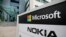  FILE - A view of Microsoft and Nokia signs in Peltola, Oulu, Finland July 16, 2014. 