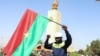 Un homme tient un drapeau du Burkina Faso lors d'un rassemblement de souteien au coup d'État qui a renversé le président Roch Kaboré, Ouagadougou le 25 janvier 2022. REUTERS/Vincent Bado