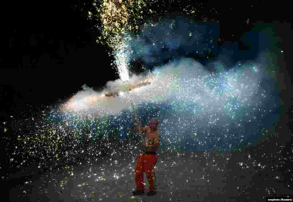 A performer takes part in a folk dance with firecrackers on the Lantern Festival to mark the end of the Lunar New Year celebrations, in Shijiazhuang, Hebei province, China, Feb. 5, 2023.