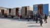 Men inspect the cargo of trucks carrying aid supplies provided by the United Nations in the aftermath of a deadly earthquake, at Syria's Bab al-Hawa border crossing with Turkey, in the rebel-held northwestern Idlib province, Feb. 12, 2023.