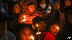 People gather at a community vigil for the Half Moon Bay shootings earlier in the week in Half Moon Bay, Calif., Jan. 27, 2023.