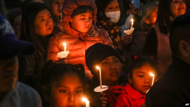 People gather at a community vigil for the Half Moon Bay shootings earlier in the week in Half Moon Bay, Calif., Jan. 27, 2023.