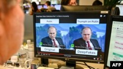 FILE - An AFP journalist watches a video manipulated with artificial intelligence to potentially deceive viewers, or 'deepfake,' at his desk in Washington, Jan. 25, 2019.