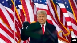 FILE - Then-President Donald Trump gestures as he arrives to speak at a rally on Jan. 6, 2021, in Washington. 