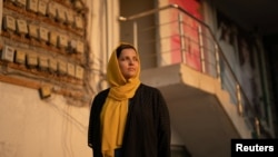 FILE - Obaida Sharar, one of the 30 female Afghan prosecutors seeking international protection, stands near the door of her building in the outskirts of Islamabad, Pakistan, Dec. 11, 2022. Sharar now lives with her family in Spain.