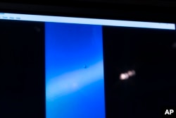 FILE - A video of an unidentified aerial phenomena is paused for display during a hearing on Capitol Hill, in Washington, May 17, 2022.