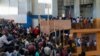 FILE - Haitians wait to apply for passports at the Vincent gymnasium in Port-au-Prince on Jan. 23, 2023.