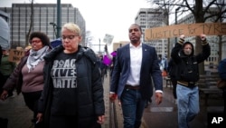 Memphis City Councilman JB Smiley Jr., center, marches with local activists demanding justice for Tyre Nichols, who died after being beaten by Memphis police during a traffic stop, in Memphis, Tenn., on Jan. 28, 2023. 