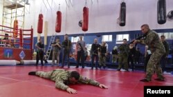 Participants watch instructors during military training for civilians at the sports and patriotic club "Yaropolk" in Krasnogorsk, outside Moscow, Russia, Dec. 3, 2022.